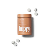 huppy cinnamon toothpaste tablets - terracotta-coloured refillable tin with white tablets scattered around showing plastic-free oral care with warming spice flavour