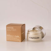 routine Bonnie N' Clyde natural deodorant jar with brown cardboard packaging showing unscented cream formula in glass container with metal lid