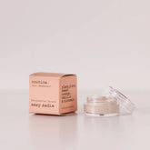 Routine Sexy Sadie baking soda free mini deodorant showing peachy-pink cardboard packaging next to open glass jar containing cream-coloured natural deodorant for sensitive skin