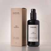 Routine The Curator natural mist bottle - black glass spray bottle with beige cardboard packaging showing botanical aromatic savvy description - eucalyptus geranium cocoa essential oil formula for body hair and atmosphere