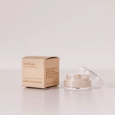 Routine The Curator baking soda-free deodorant mini - cream cardboard box beside open glass jar showing light cream deodorant