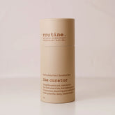 routine The Curator deodorant stick displayed on a creamy background showing cardboard packaging.