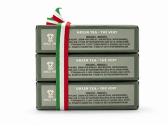 Side view of three stacked Saponificio Zeni Green Tea triple-milled soap bars in dark green paper wrap with ingredient panel and Italian tricolour ribbon