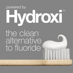 White toothbrush with wooden handle on gray background featuring Hydroxi branding.