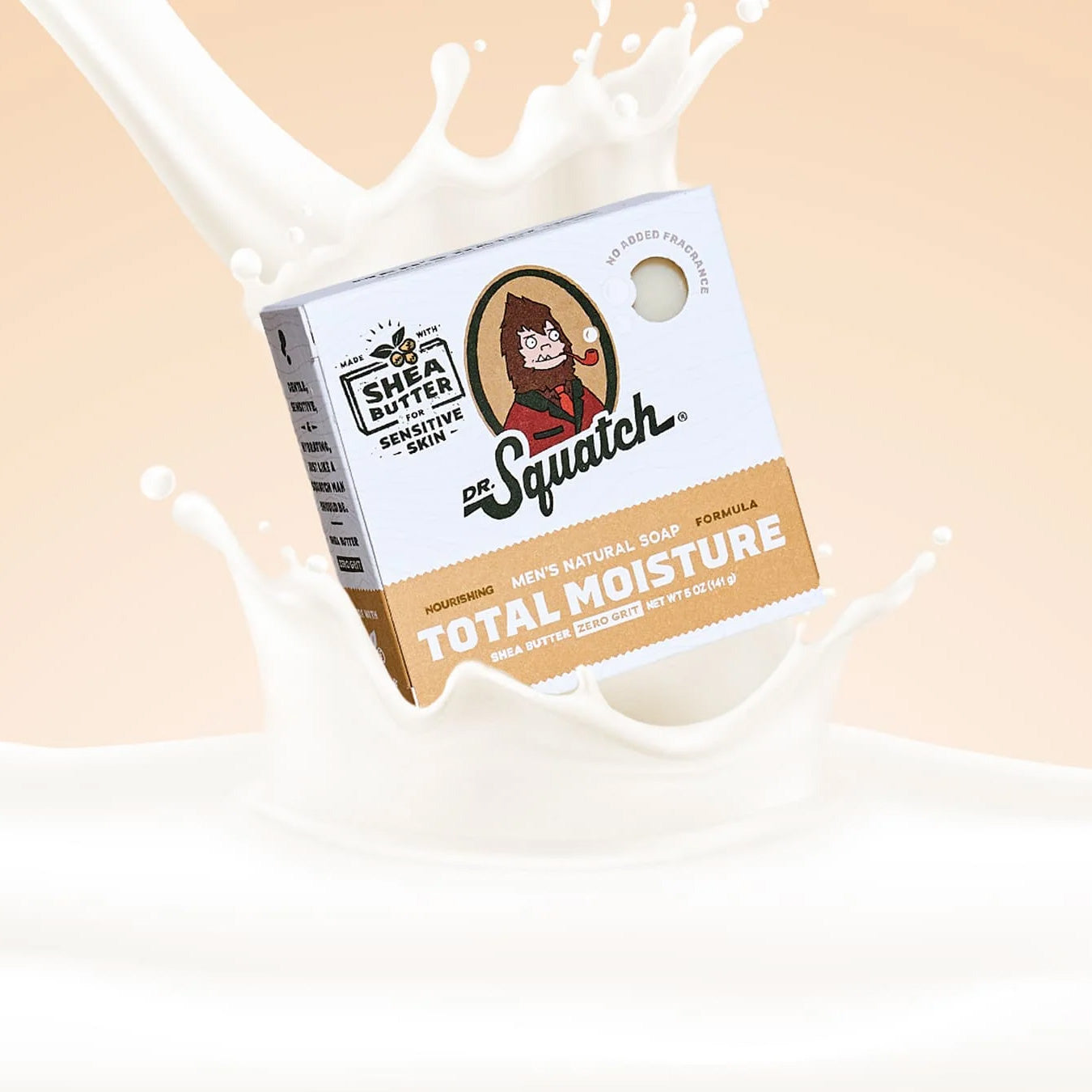 Dr. Squatch soap bar packaging with a splash of milk on a beige background