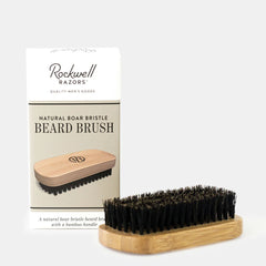 Rockwell natural boar bristle beard brush with bamboo handle displayed against packaging showing quality men's grooming tool for beard care.