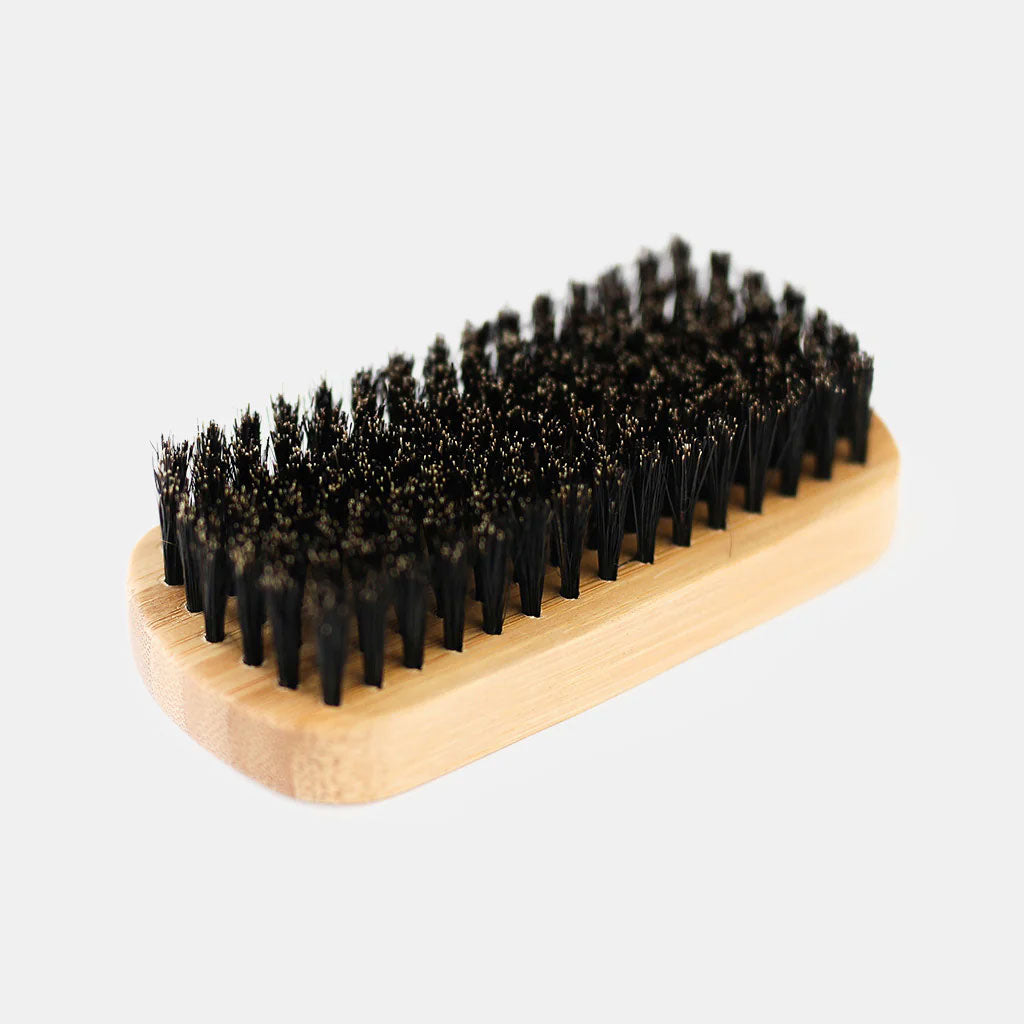 Close-up detail of dense natural black boar bristles on Rockwell beard brush showing premium bristle density and quality construction.