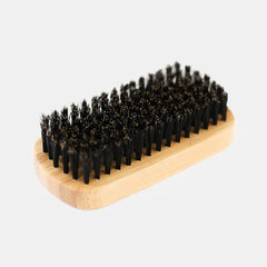 Close-up detail of dense natural black boar bristles on Rockwell beard brush showing premium bristle density and quality construction.