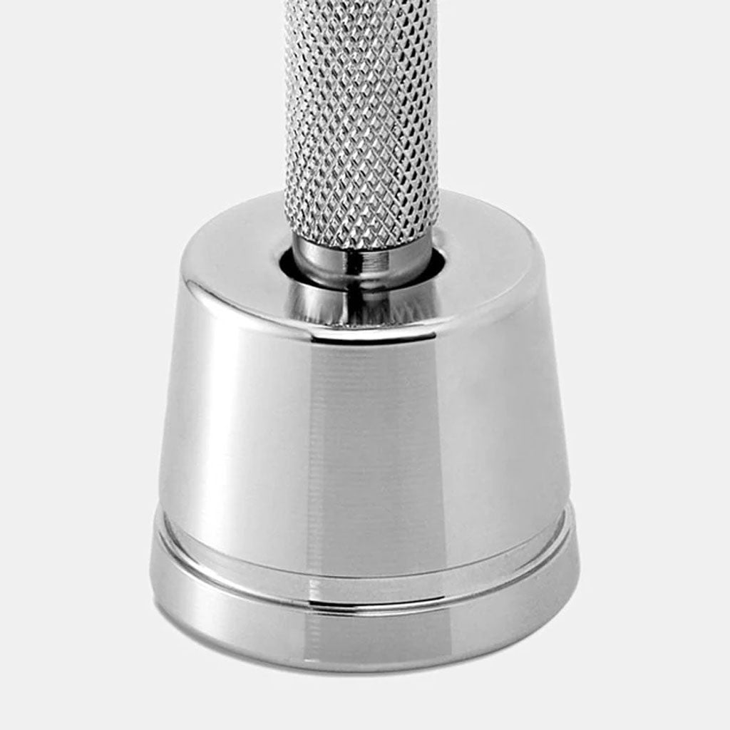Close-up of Rockwell razor stand with safety razor inserted showing proper upright storage position that allows water drainage and blade drying.