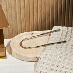 huppy tongue cleaner lifestyle shot - stainless steel scraper positioned on modern stone bathroom tray with textured towel, demonstrating elegant bathroom integration and daily use context