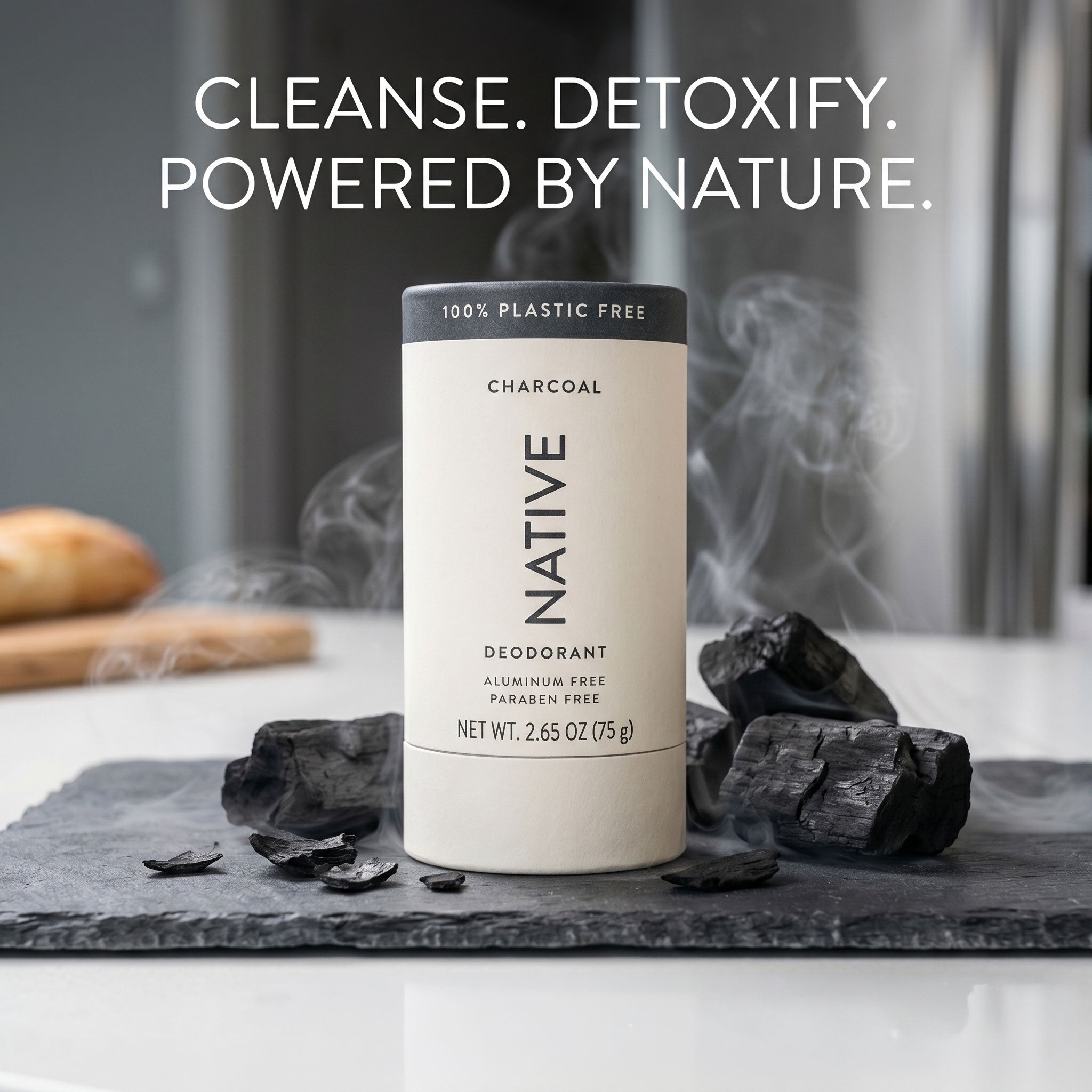 Native Charcoal plastic-free deodorant tube styled on a slate board with chunks of charcoal and rising smoke, headline reading "Cleanse. Detoxify. Powered by Nature."