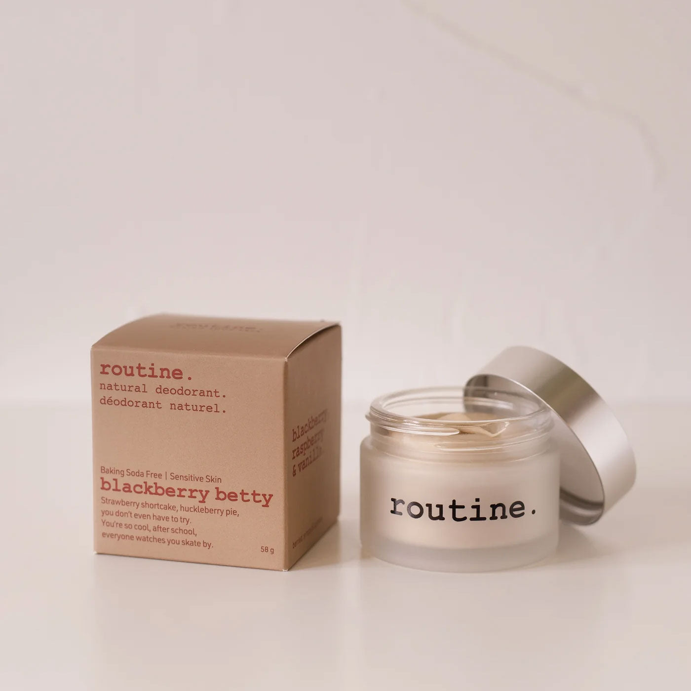 routine Blackberry Betty natural baking soda free deodorant jar with cardboard packaging - cream-coloured deodorant in glass container next to brown box showing berry scent description - baking soda free formula for sensitive skin