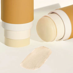 Routine Bonita Applebom deodorant with its cap removed, revealing the pale-yellow stick beside a swatch of its creamy texture on a beige-toned surface.