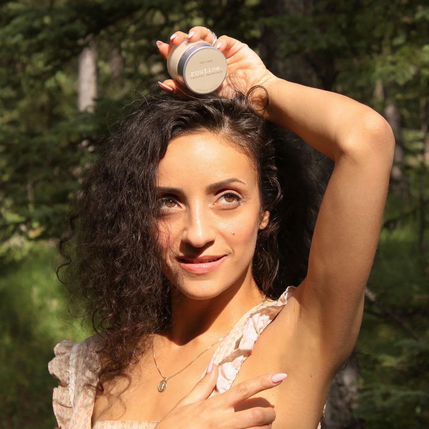 routine Cat Lady deodorant lifestyle - woman holding small glass jar outdoors demonstrating portable size and natural beauty routine for confident daily use
