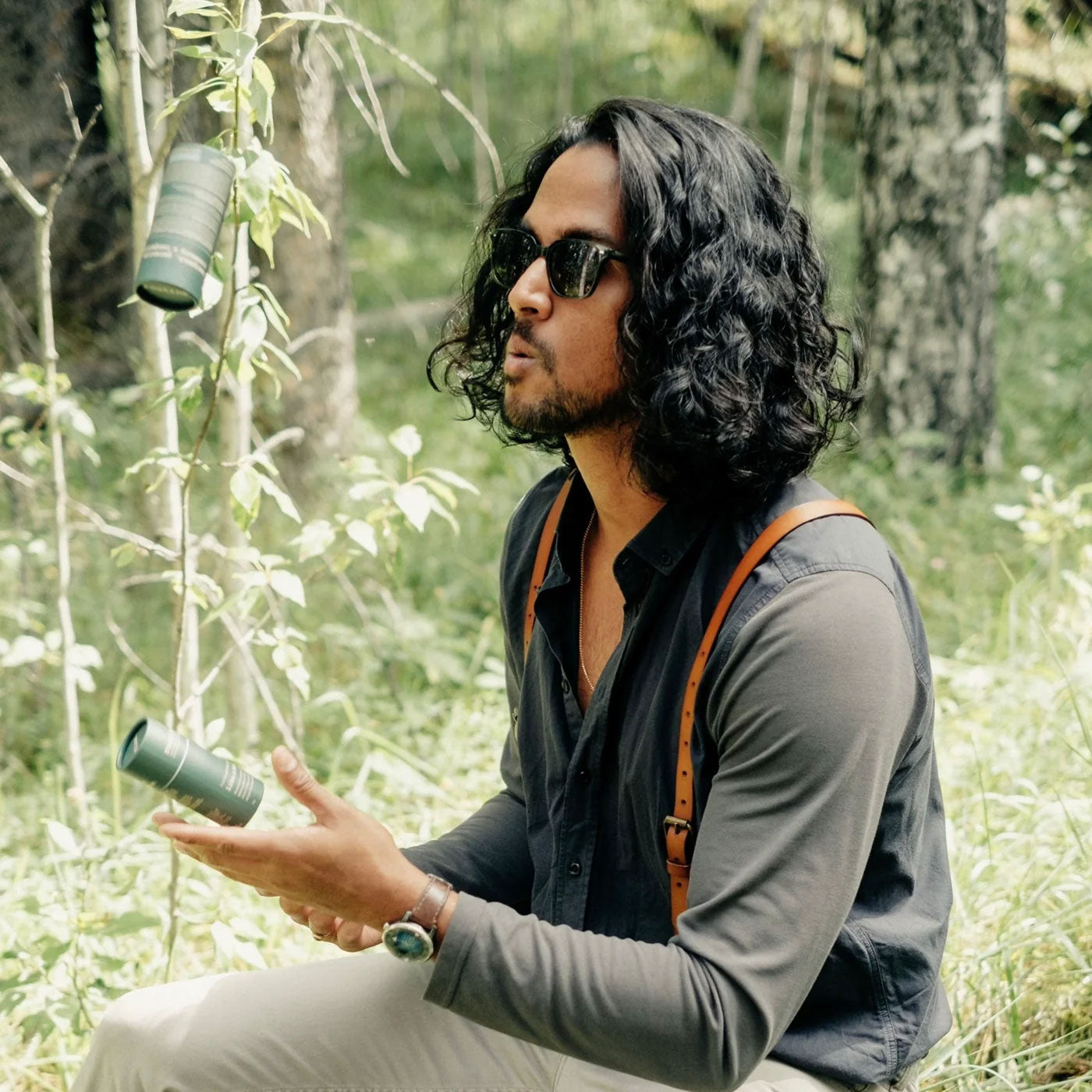 A man outdoors holding Like A Boss Deodorant Stick showing on-the-go freshness in nature.