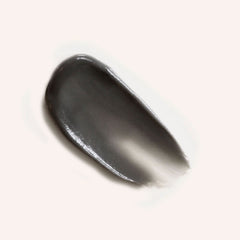 Moon Sisters deodorant cream swatch - dark grey activated charcoal formula showing smooth, creamy texture when applied - natural prebiotic deodorant for sensitive skin types