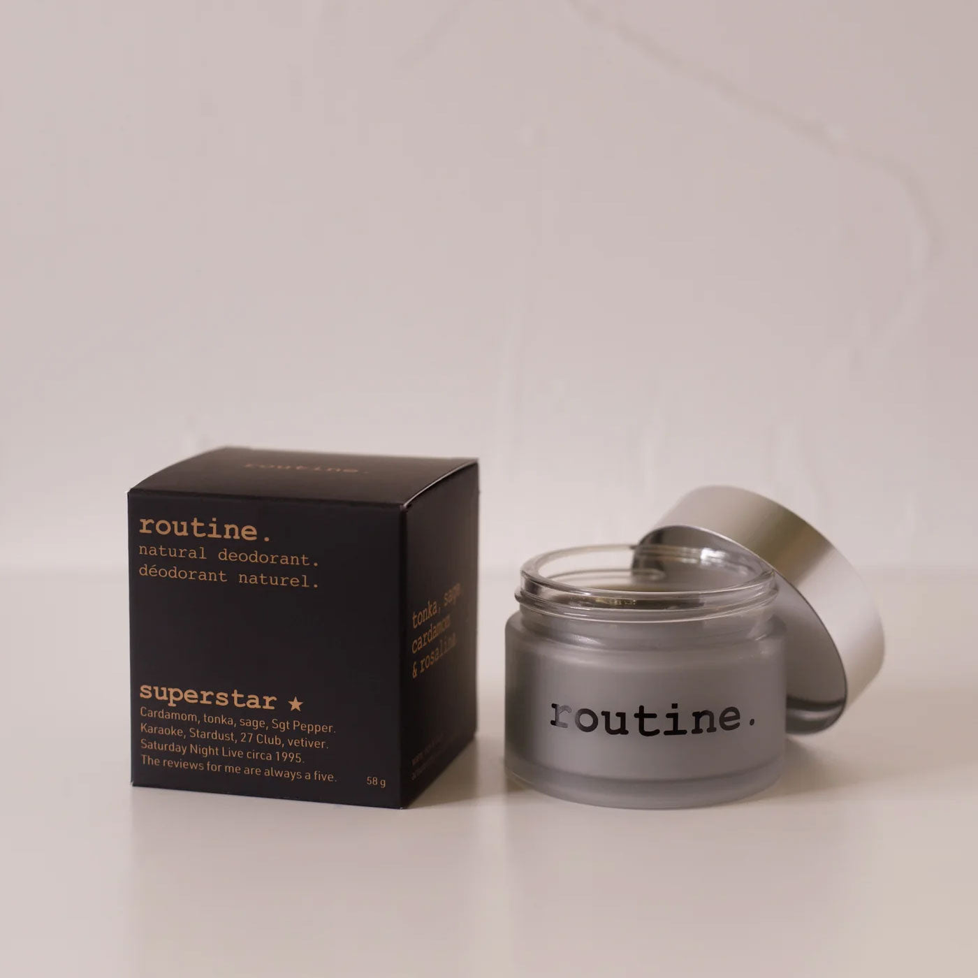 routine Superstar natural deodorant jar with black packaging - frosted glass container showing charcoal-infused cream formula for multi-area odour protection