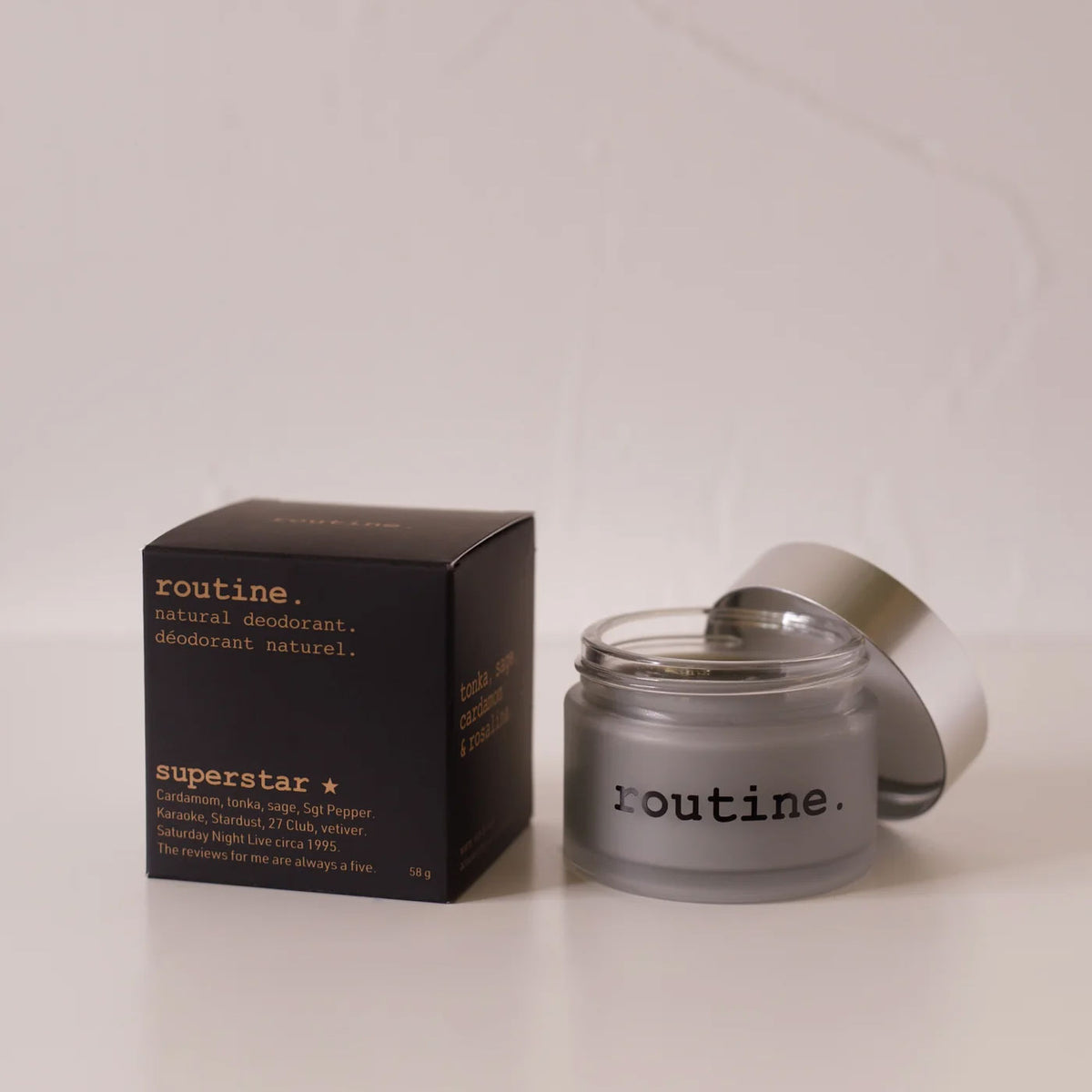 routine Superstar natural deodorant jar with black packaging - frosted glass container showing charcoal-infused cream formula for multi-area odour protection