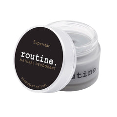 r
routine Superstar deodorant jar opened showing dark grey cream texture - activated charcoal and prebiotic formula with warm tonka sage scent for sensitive skin