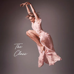 Woman in flowing pink dress jumping gracefully with The Class branding - artistic lifestyle image representing transformation and confidence through luxury natural beauty products