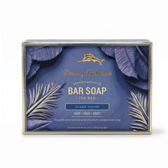 Front of Tommy Bahama Ocean Waves Bar Soap for Men box featuring gold marlin logo, palm leaf illustration, and 10 oz / 283 g net weight on navy background