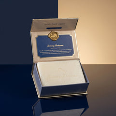 Tommy Bahama Ocean Waves Bar Soap displayed in opened blue and gold gift box against a navy and cream two-tone studio backdrop