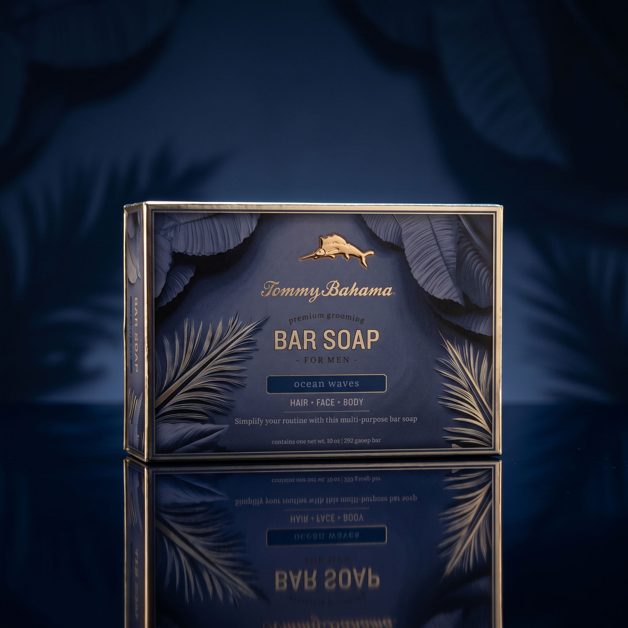 Tommy Bahama Ocean Waves Bar Soap gift box photographed on a reflective surface with dramatic blue lighting and palm-leaf background